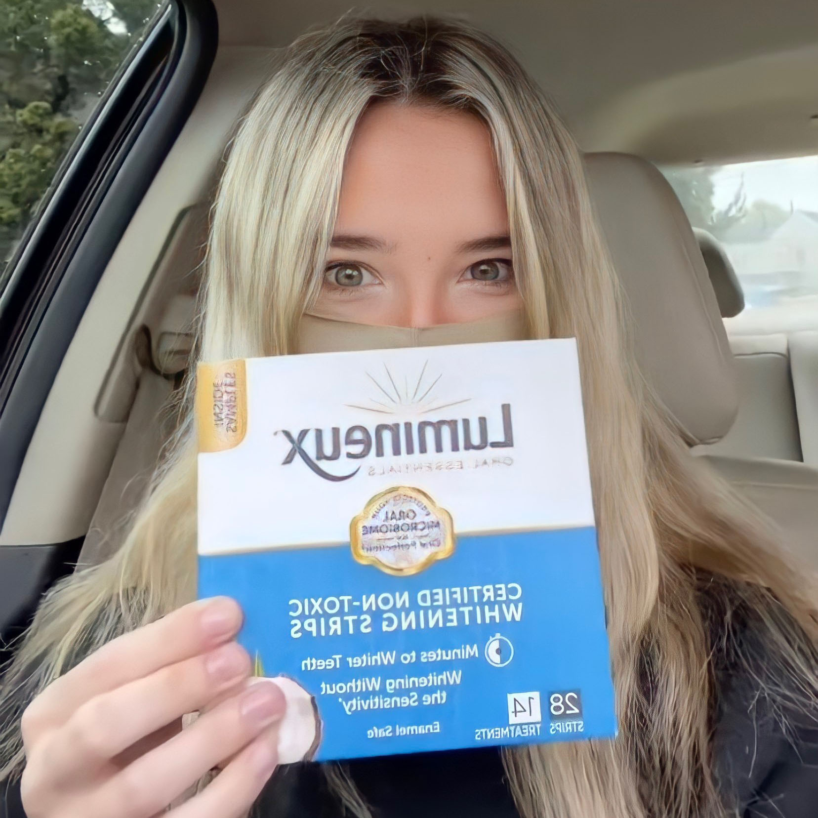 Mackenzie Skye holding her Lumineux product