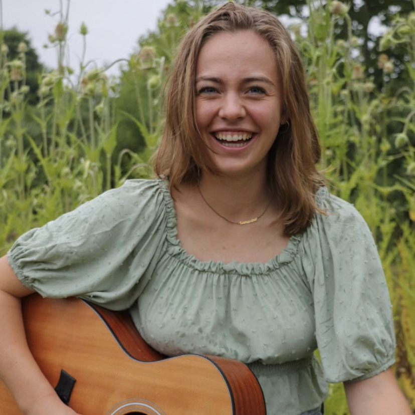 Sam Alesandri with her guitar from a photoshoot